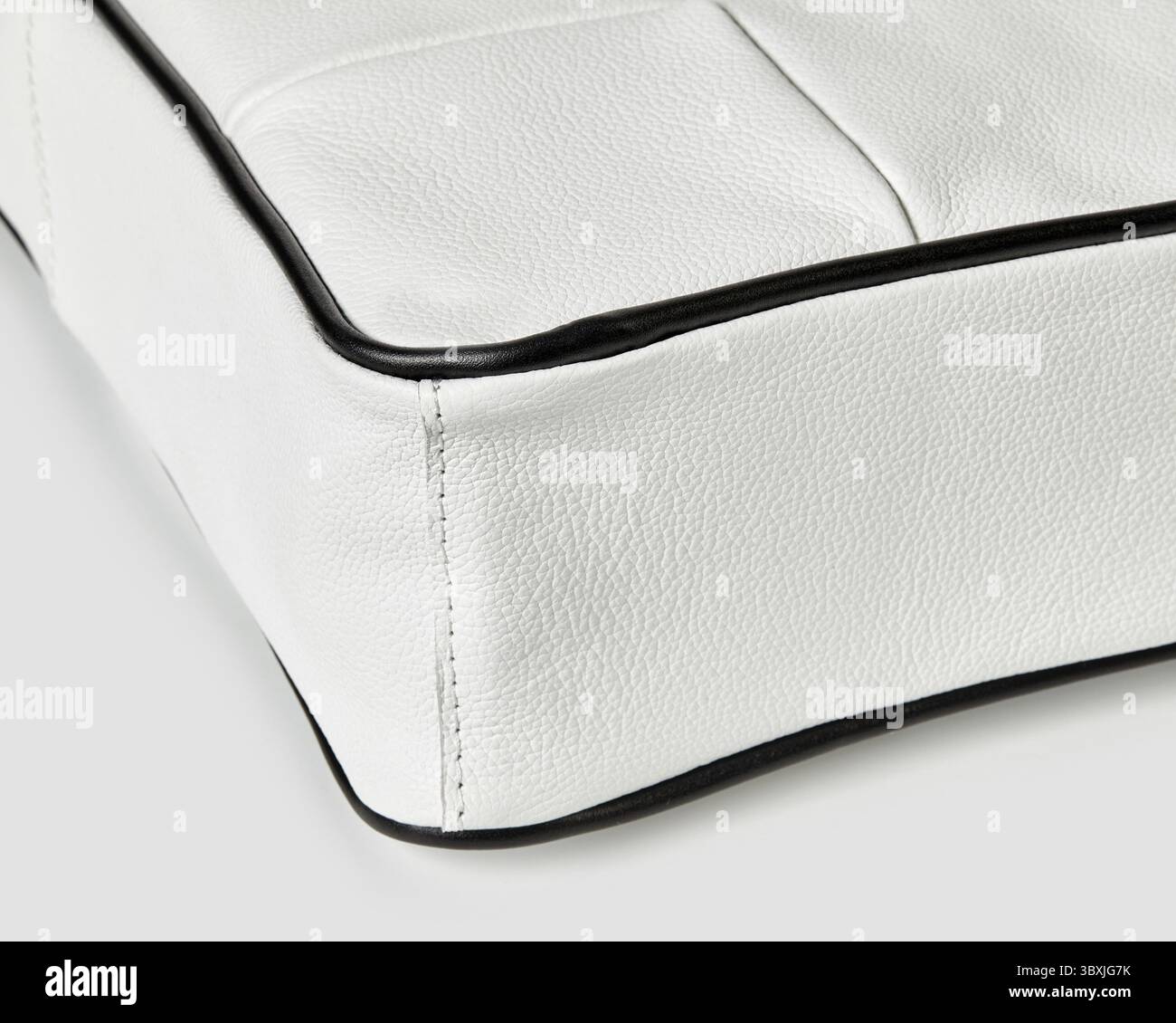 White leather bag with black piping detail, highlighting the craftsmanship and stitching Stock Photo