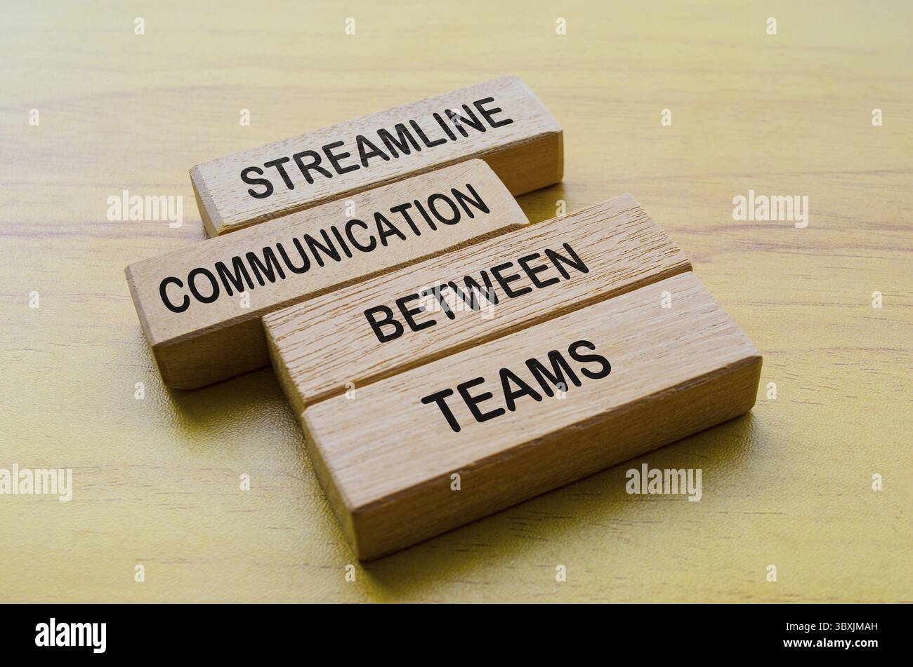 Streamline communication between teams text on wooden blocks ...