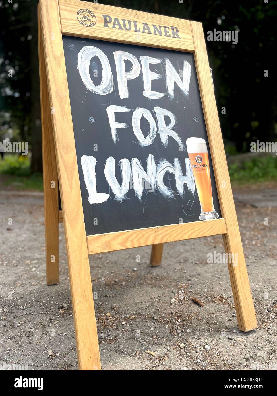 Chalkboard sidewalk sign outside a restaurant with handwritten 'Open for Lunch' message, inviting customers in, Vitosha Mountain, Eastern Europe, EU - Smartphone Captured Stock Image