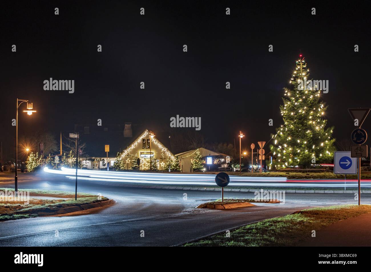 Light trails on the roundabout with Christmas decorations Stock Photo