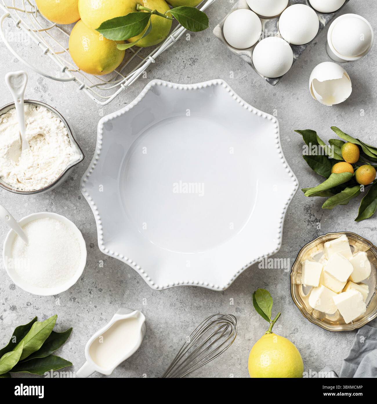 Food, White ceramic cake pan with lemons. Ingredients for making a lemon curd pie on a white stone table. Square Stock Photo