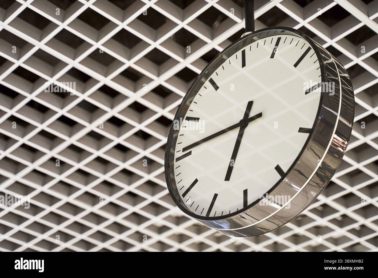 Modern clock with dial on structured wall background in black and white with chrome Stock Photo