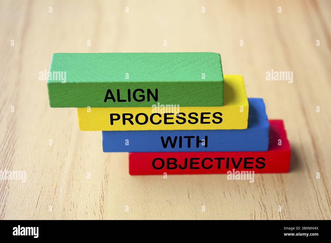 Align processes with objectives text on multicolored wooden blocks ...