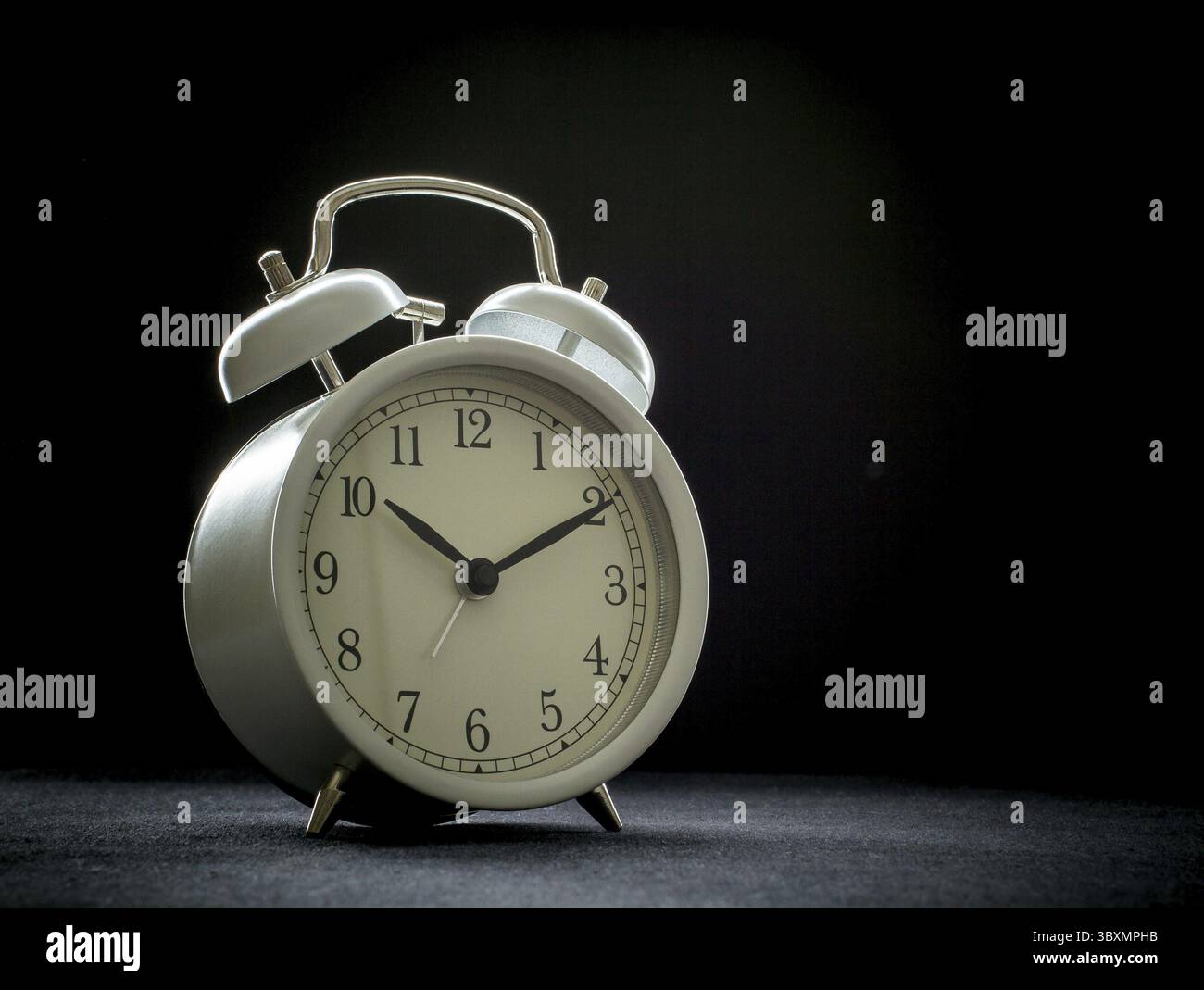 White retro alarm clocks on black background Stock Photo