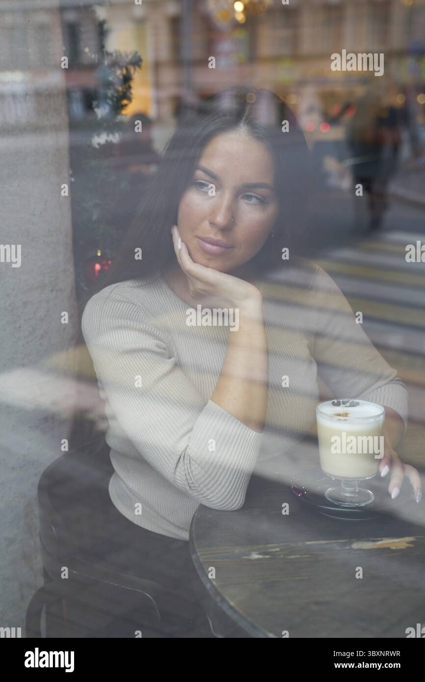 Woman looks out window drinks hi-res stock photography and images - Alamy