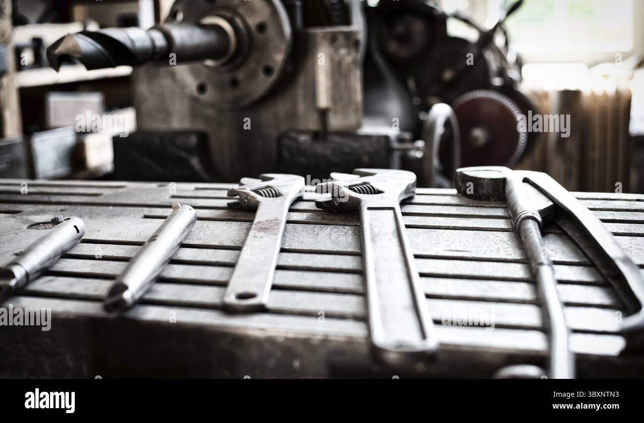 Vintage old metallic tools laying on a iron table surface Stock Photo