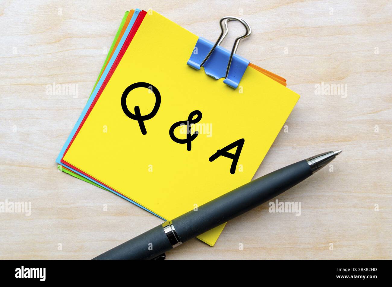 Q and A text on yellow notepad. Question and Answer concept Stock Photo