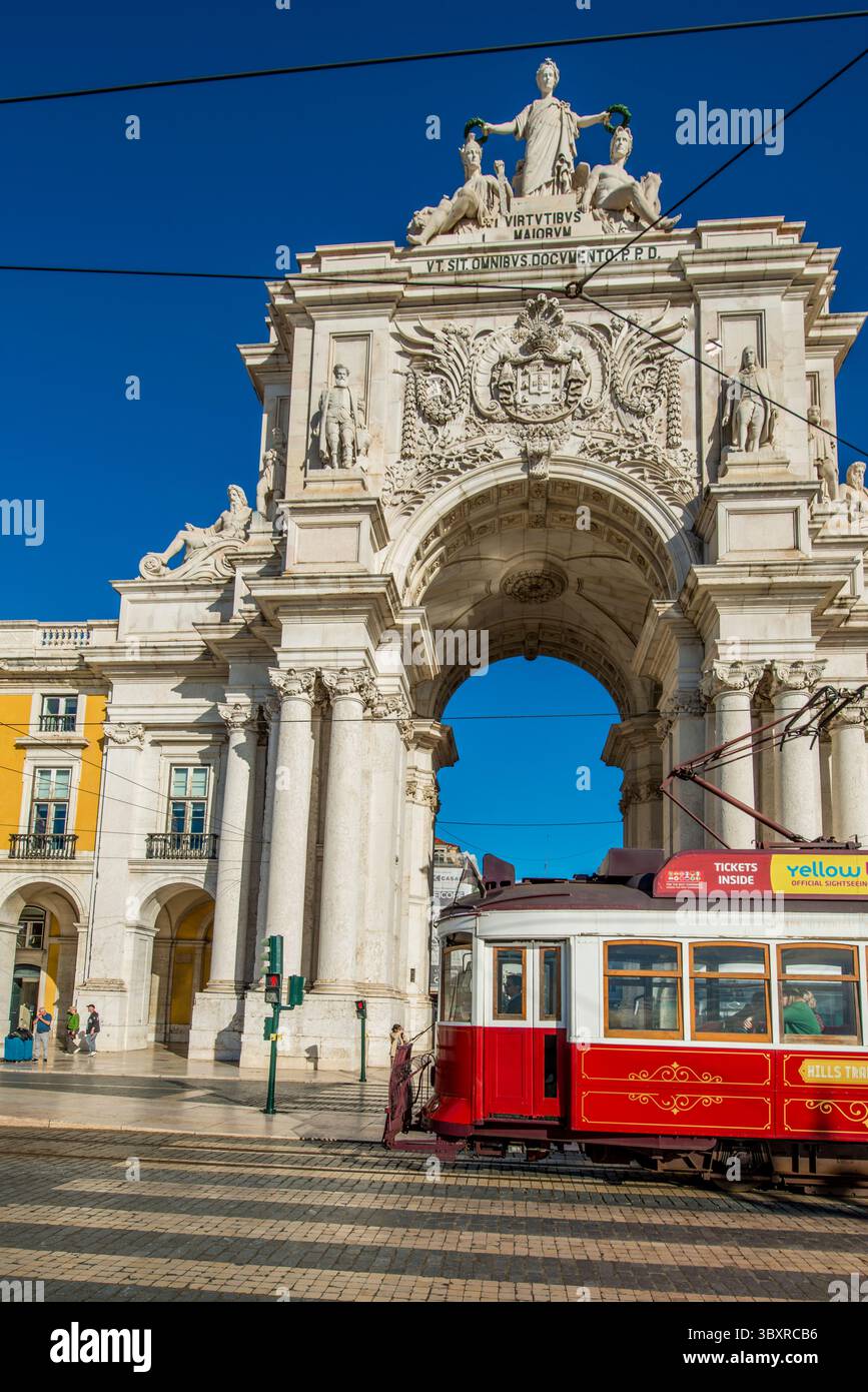 Tram passing the Arco da Rua Augusta or Triumphal Arch of Praca do Comercio, Lisbon, Portugal. Stock Photo