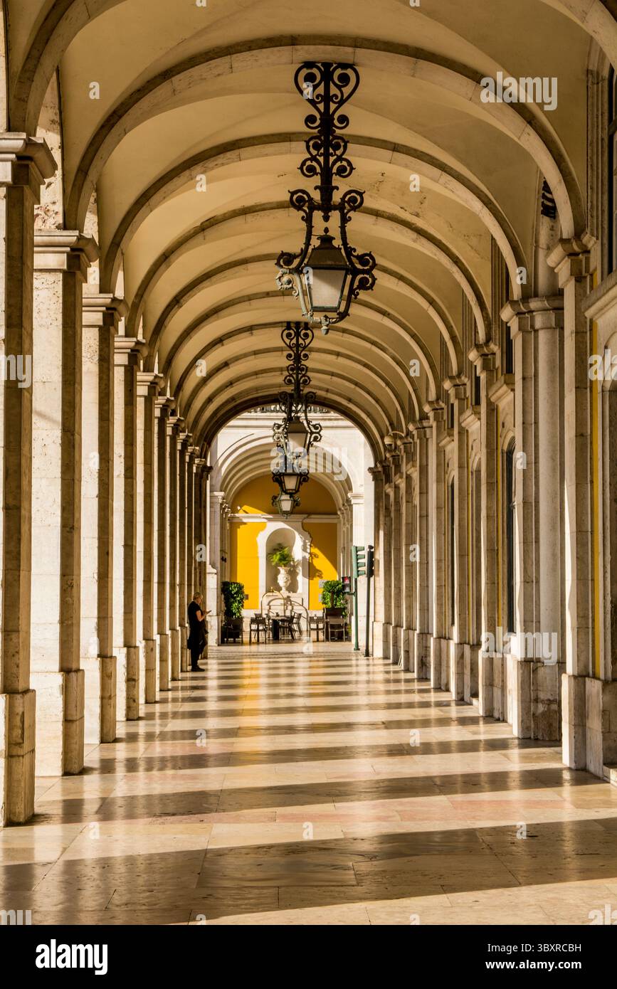 Arched sidewalk off the Arco da Rua Augusta or Triumphal Arch of Praca do Comercio, Lisbon, Portugal. Stock Photo