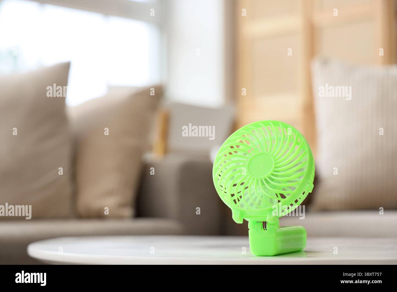 Small electric fan on table Stock Photo