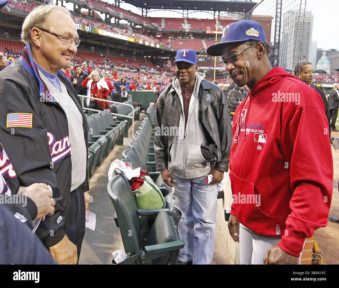 Texas Rangers owner Tom Hicks, right, talks with team president and former pitcher Nolan Ryan during the Rangers baseball against the Baltimore Orioles in Arlington, Texas, Tuesday, April 8, 2008. (AP Photo/LM