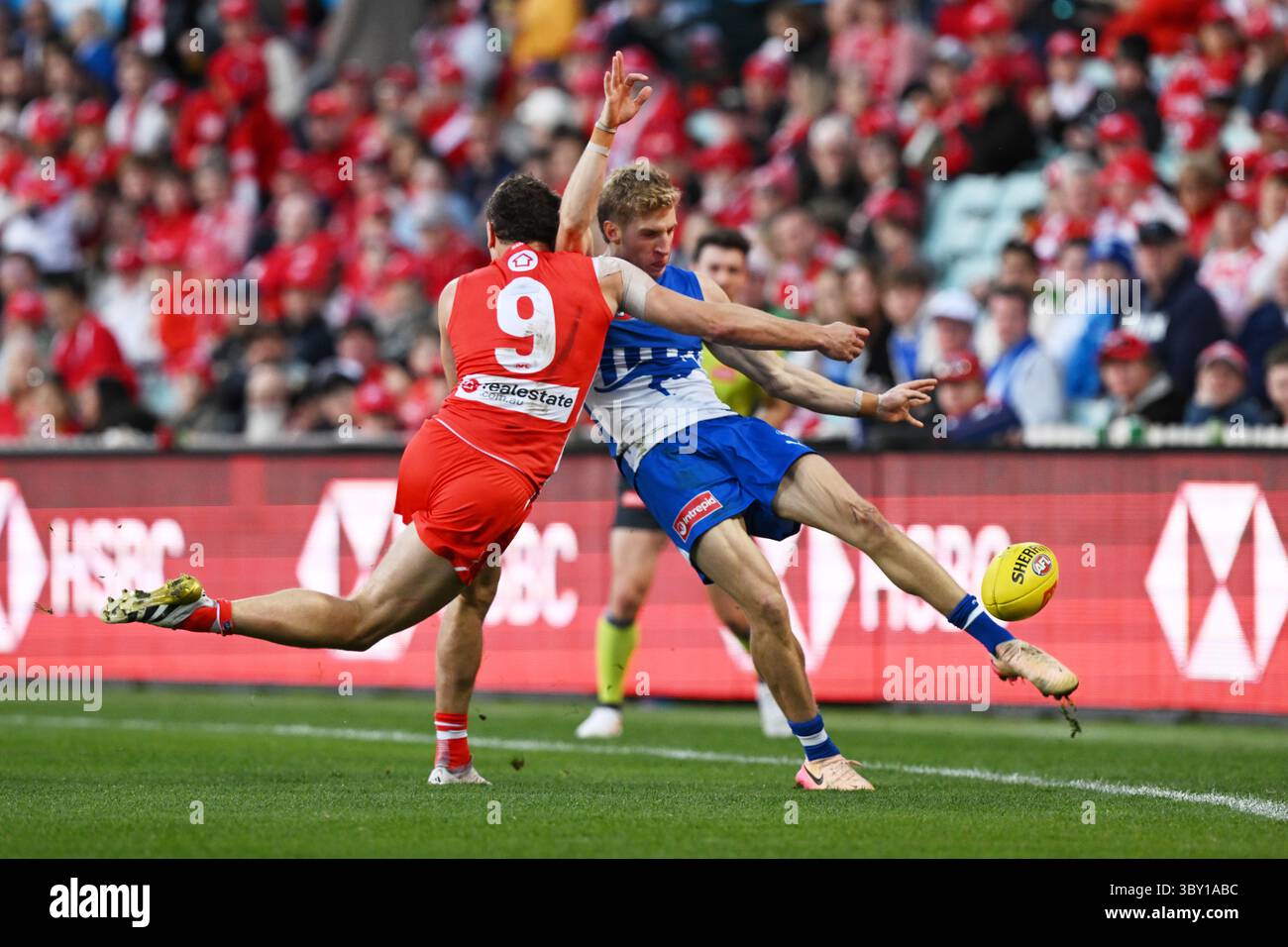 Dylan Stephens Dylan Stephens of the Kangaroos gets a kick away despite pressure from ...