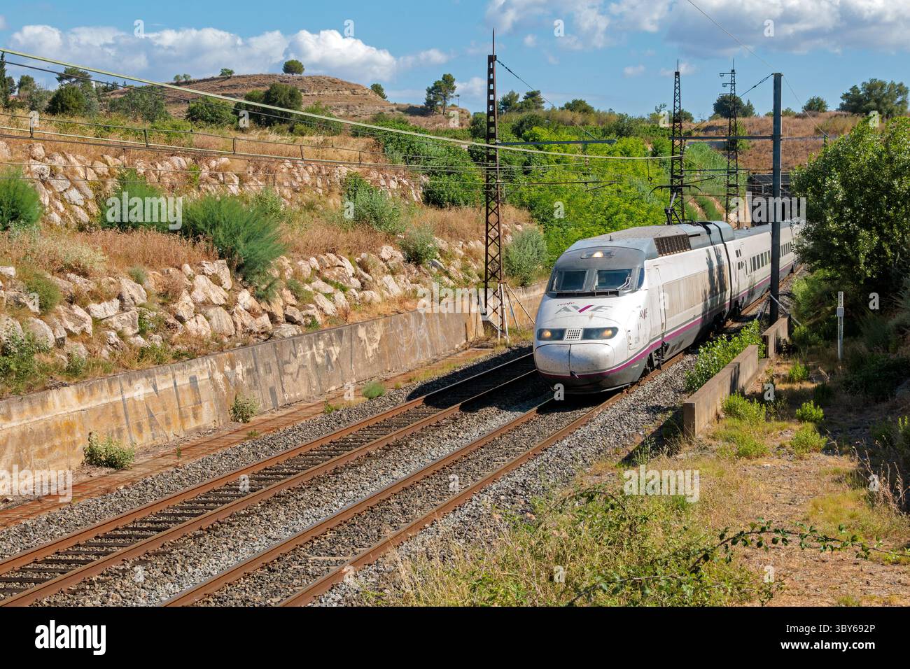 TGV train of the Spanish company Renfe traveling between Beziers and Narbonne. Passage of the Malpas tunnel under the hill of Enserune. Occitanie, France Stock Photo