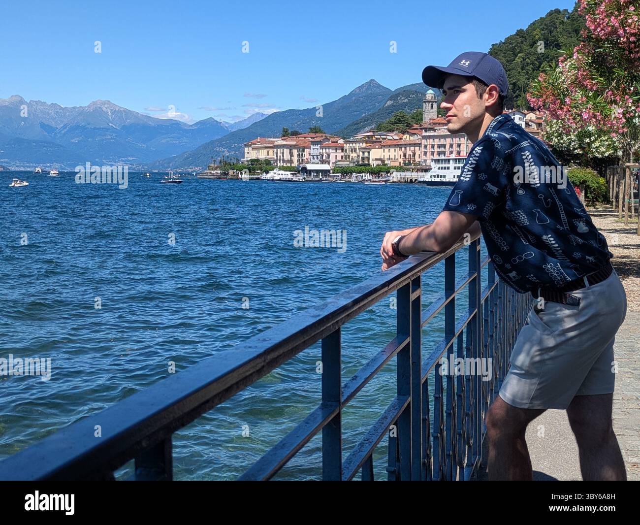 man leaning on railing at Bellagio Lake Como Stock Photo