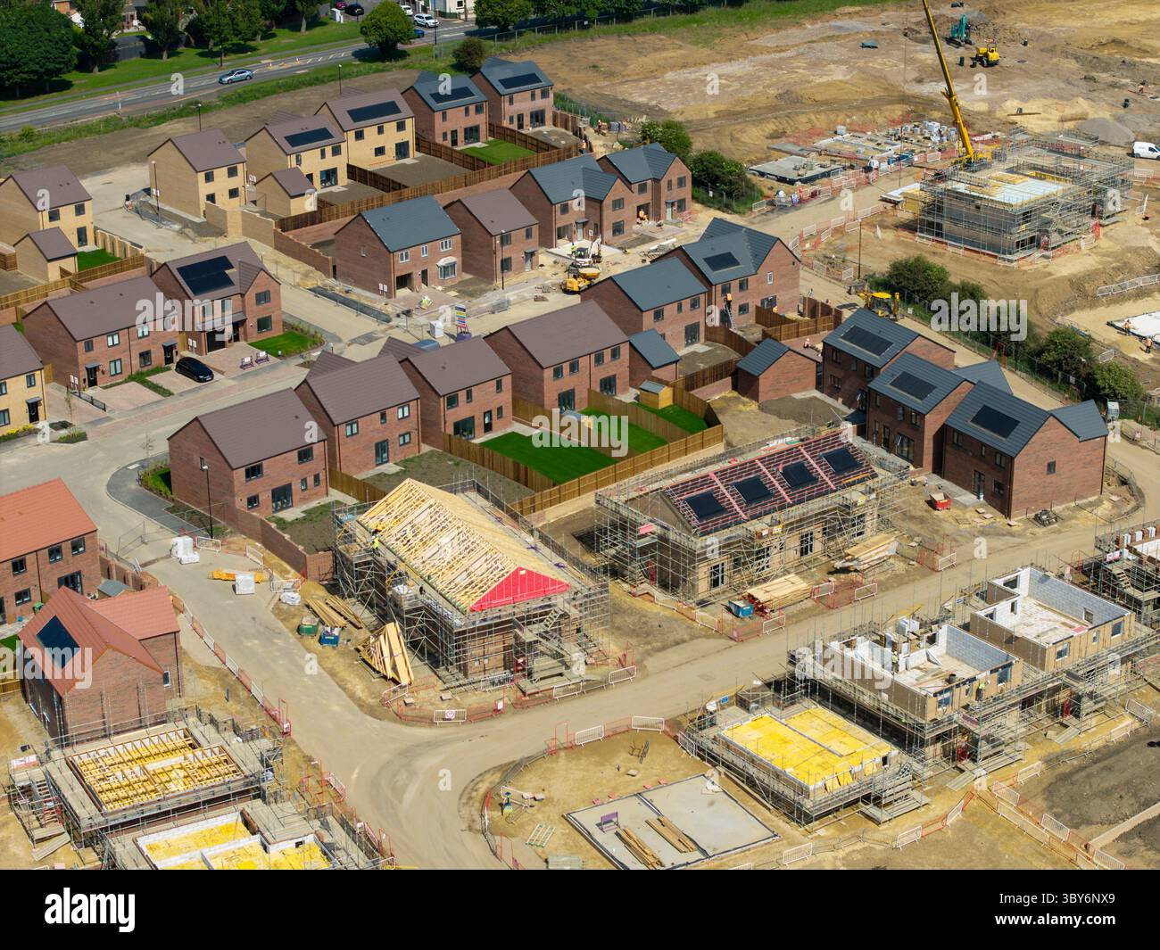 Construction site with completed and uncompleted houses. Built-in solar ...