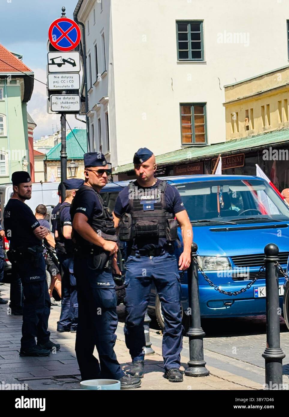 Polish policemen securing the German consulate during an anti-immigration protest in Kraków, Poland. - Smartphone Captured Stock Image