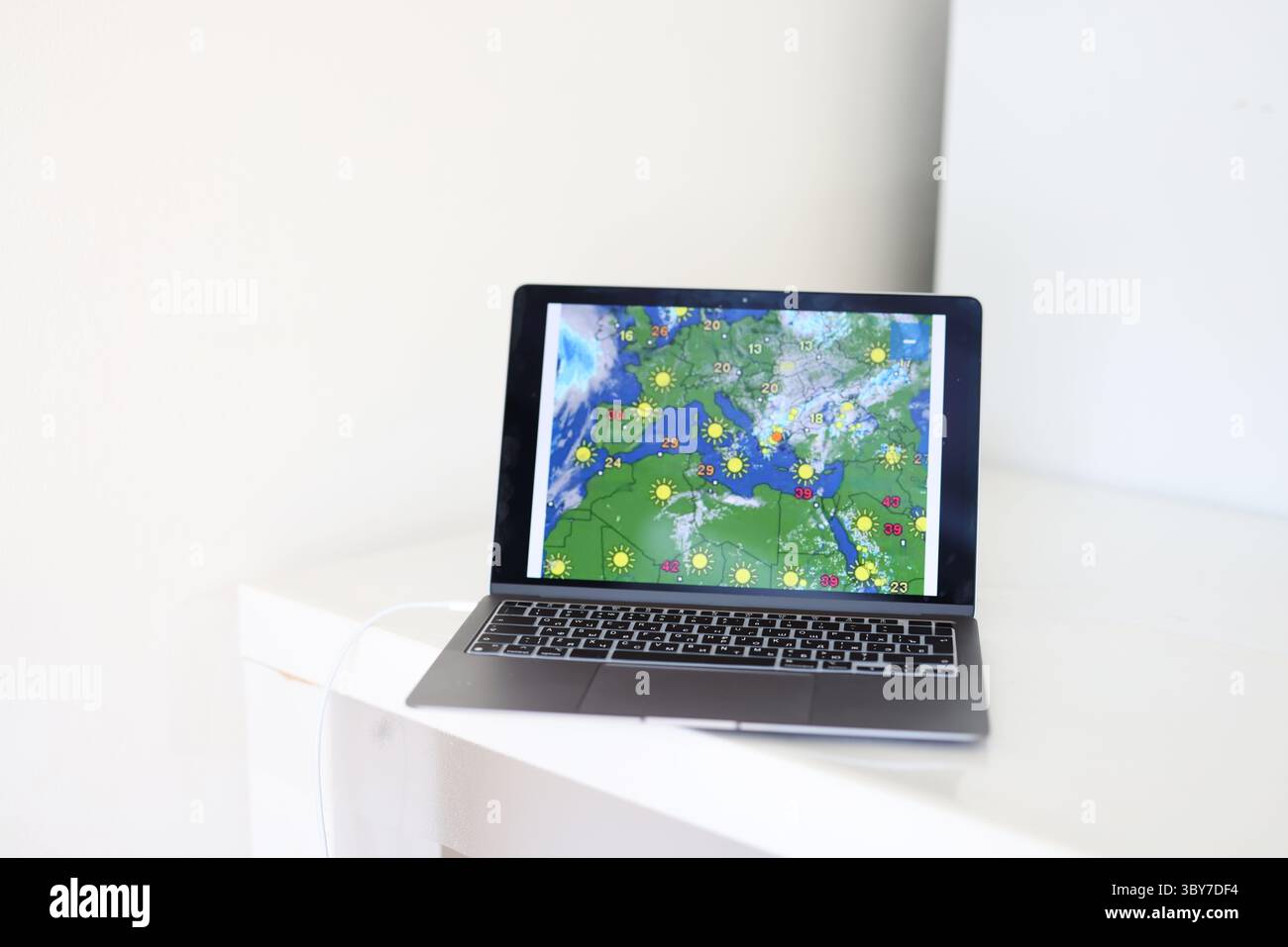 laptop to follow weather changes, forecasting, technology, environment. Stock Photo