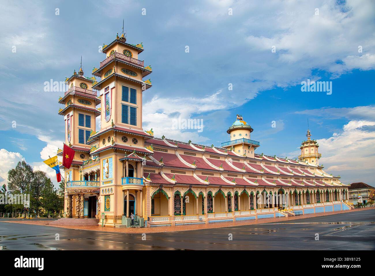 Cao Dai temple area and meditating followers of the Cao Dai religion in ...