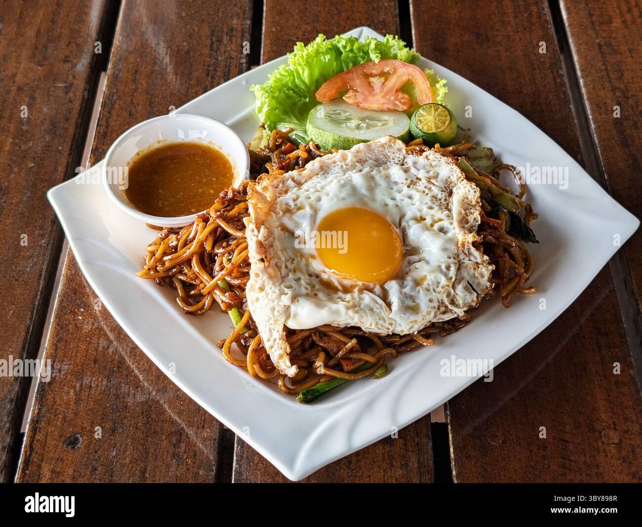 Mamak Fried Noddle with Sambal and Sunny Side-Up Egg Malaysian food Stock Photo