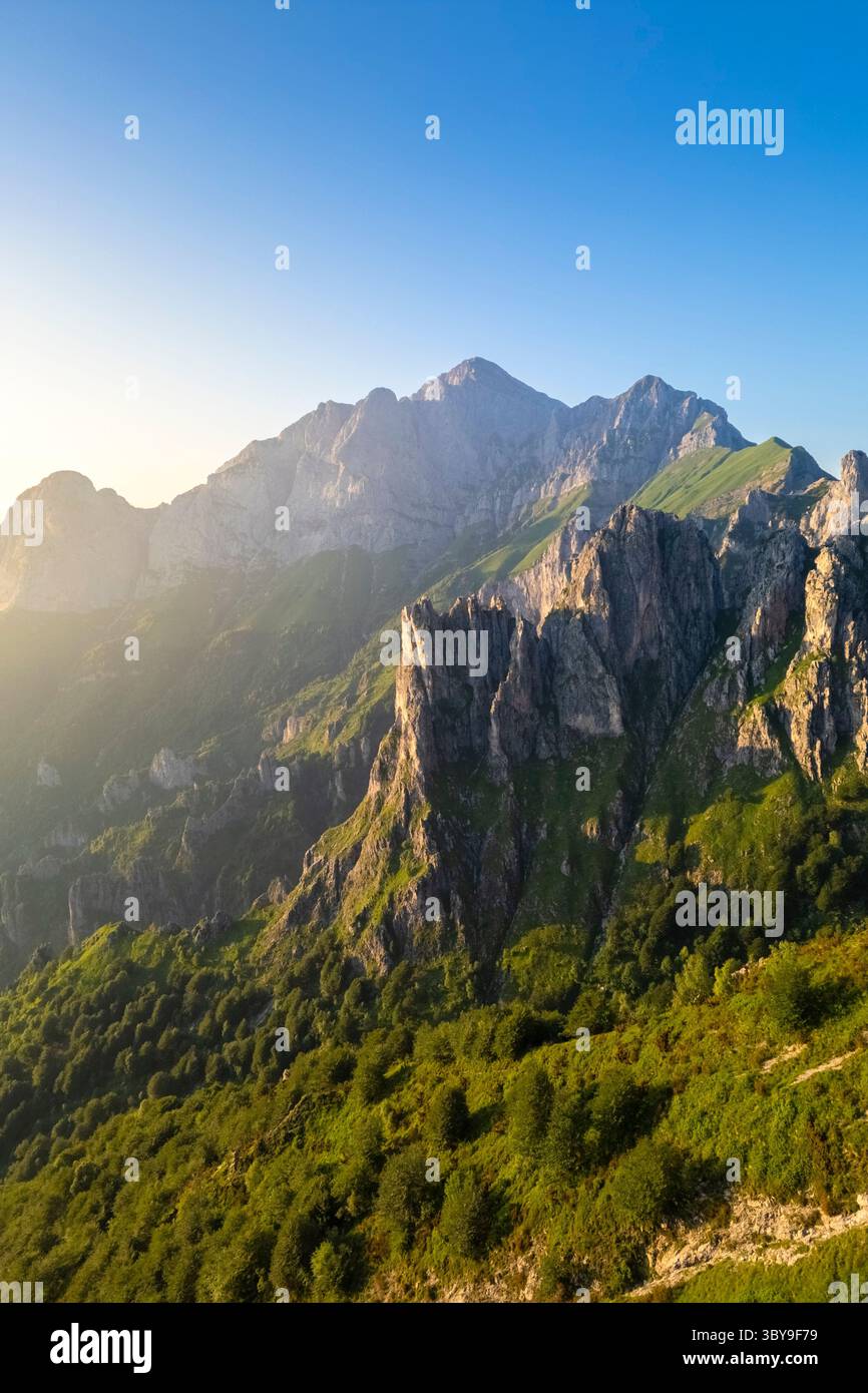 Aerial view of the rock pinnacles in front of Grigna (Grigna Settentrionale) in summer at sunset. Piani Resinelli, Lecco, Lombardy, Italy. Stock Photo