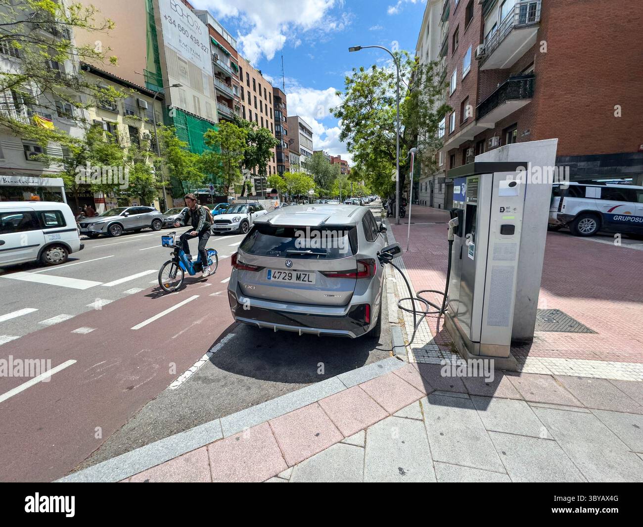 BMW iX1 charging in an EV electric charger in Santa Engracia, Chamberi, EV veMadrid, Spain - Smartphone Captured Stock Image