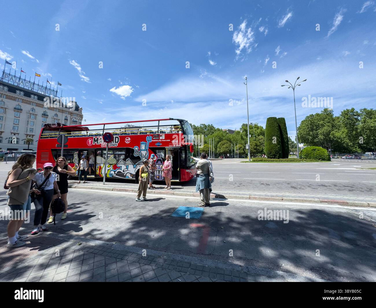 City Tour bus, Fuente de Neptuno in Plaza de Cánovas del Castillo (commonly called Plaza de Neptuno), on Paseo del Prado, Madrid, Spain - Smartphone Captured Stock Image