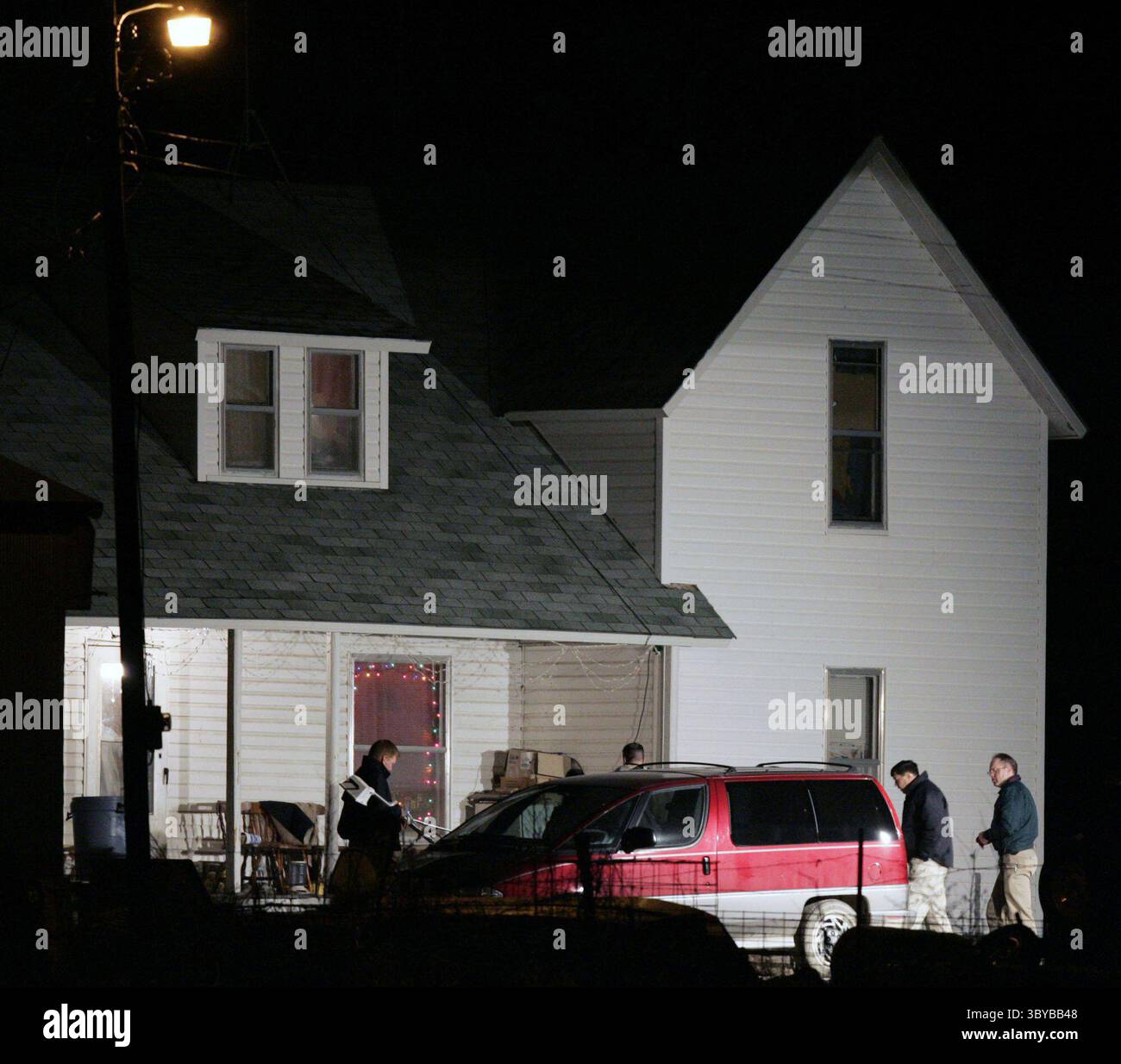Dec 17, 2004 - Malvern, Kansas, USA - Police investigators search outside the home of Lisa and Kevin Montgomery. Lisa M. Montgomery, was convicted in a kidnapping, resulting in death in the abduction of an eight-month-old fetus, and the killing of the mother, Bobbie Jo Stinnett.  (Credit Image: © Joe Ledford/The Kansas City Star/TNS/ZUMAPRESS.com) Stock Photo