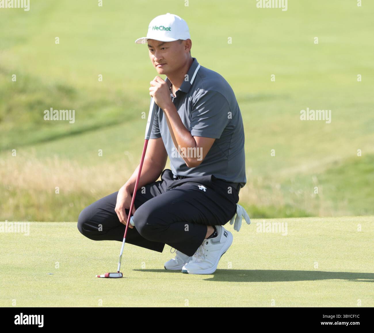 China's Haotong Li lines up a putt on the ninth green during the Third ...