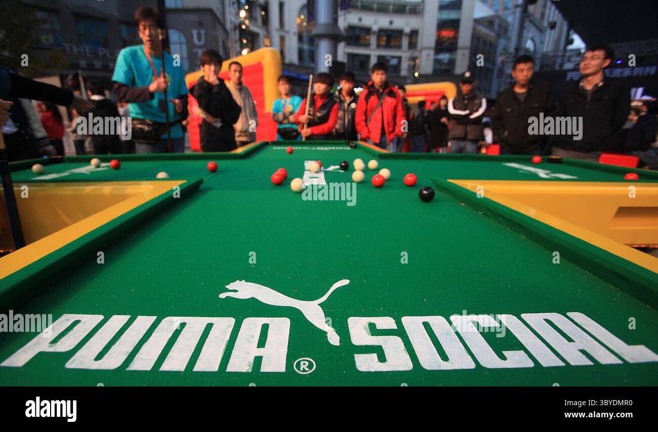November 5, 2011, BEIJING, CHINA: Chinese play a form of snooker for prizes at a concert sponsored by Puma, a leading sports lifestyle company, at an international fashion mall in Beijing November 5, 2011.  Foreign companies hoping to do business in China often hire local musicians, celebrities and athletes to help promote their brand to the largest consumer market in the world. (Credit Image: © Stephen Shaver/ZUMA Press Wire) Stock Photo