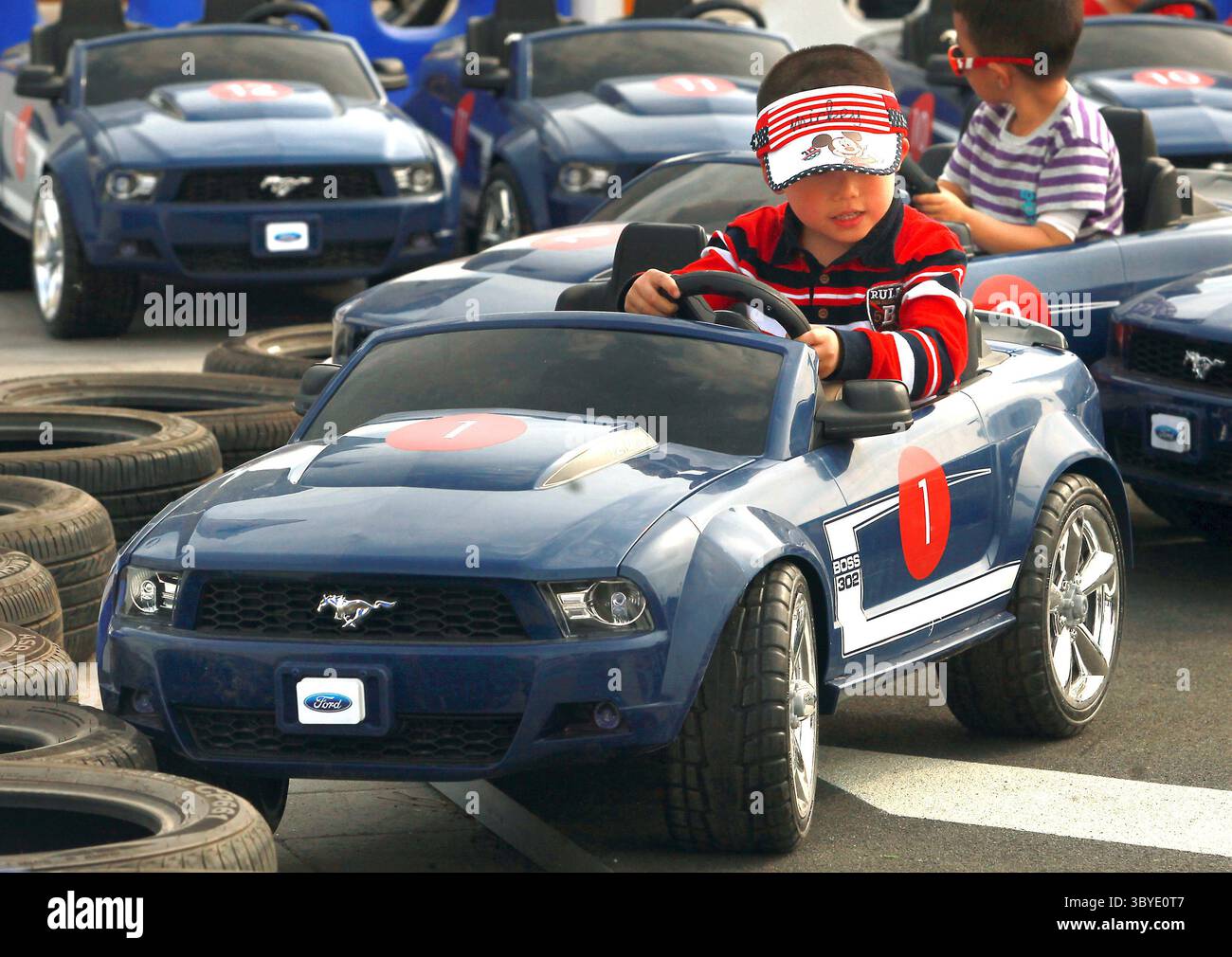Chinese kids race electric miniature Ford Mustangs at Auto China 2014,  billed as one of the largest auto shows in the world, in Beijing on April  24, 2014. Strong demand for new cars throughout China has laid the  foundation for domestic and international ...