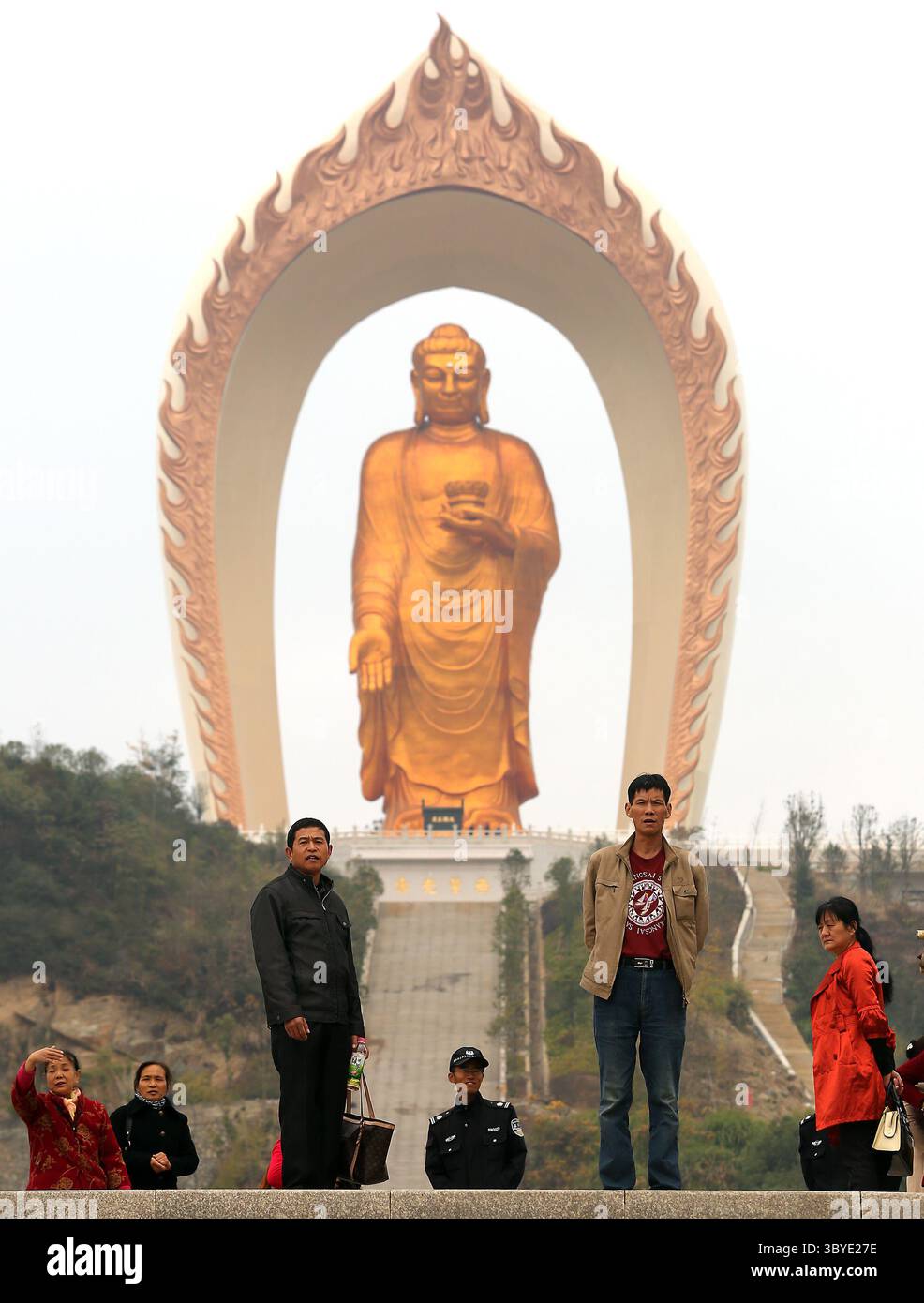 November 19, 2014, WENQUAN, JIANGXI PROVINCE, CHINA: Chinese tourists visit the Donglin Buddha, located in the foothills of Lushan Mountain in east China's Jiangxi Province, on November 19, 2014.  The Buddha statue is  the world's highest Amitabha statue, according to the government.  China has slowly, but positively embraced ecotourism as unchecked development across the country has begun threatening cultural heritage areas and the traditional ways of life in ethnic-rich provinces. (Credit Image: © Stephen Shaver/ZUMA Press Wire) Stock Photo