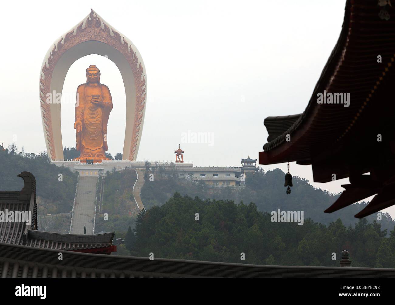 November 19, 2014, WENQUAN, JIANGXI PROVINCE, CHINA: Chinese tourists visit the Donglin Buddha, located in the foothills of Lushan Mountain in east China's Jiangxi Province, on November 19, 2014.  The Buddha statue is  the world's highest Amitabha statue, according to the government.  China has slowly, but positively embraced ecotourism as unchecked development across the country has begun threatening cultural heritage areas and the traditional ways of life in ethnic-rich provinces. (Credit Image: © Stephen Shaver/ZUMA Press Wire) Stock Photo