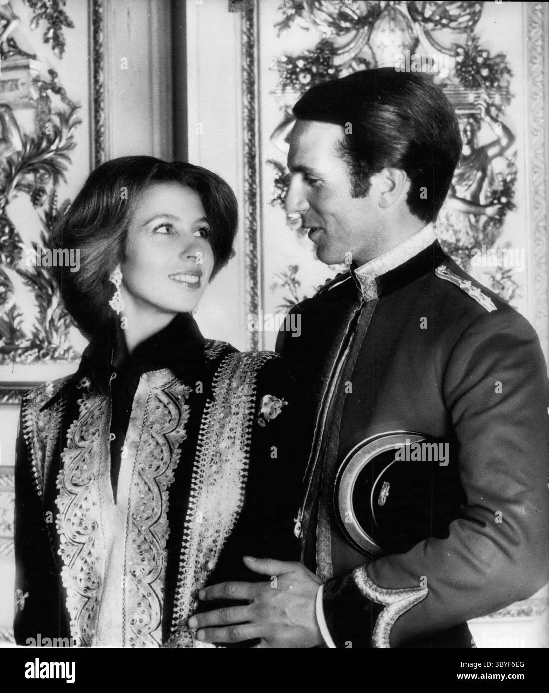 Nov. 06, 1973 - HRH Princess Anne And Captain Mark Philips; The marriage of HRH Princess Anne and Captain Philips of the Queen's Dragoon Guards will take place on November 14th - 1973 at Westminster Abbey. Princess Anne is wearing a black silk shirt and trousers with a black and gold caftan, pearl and diamond earrings set in gold. Captain Philips is in the Mess Kit of his regiment. The photograph was taken in the Crimson Drawing Room at Windsor Castle.  (Credit Image: © Keystone Press Agency/ZUMA Press Wire) Stock Photo