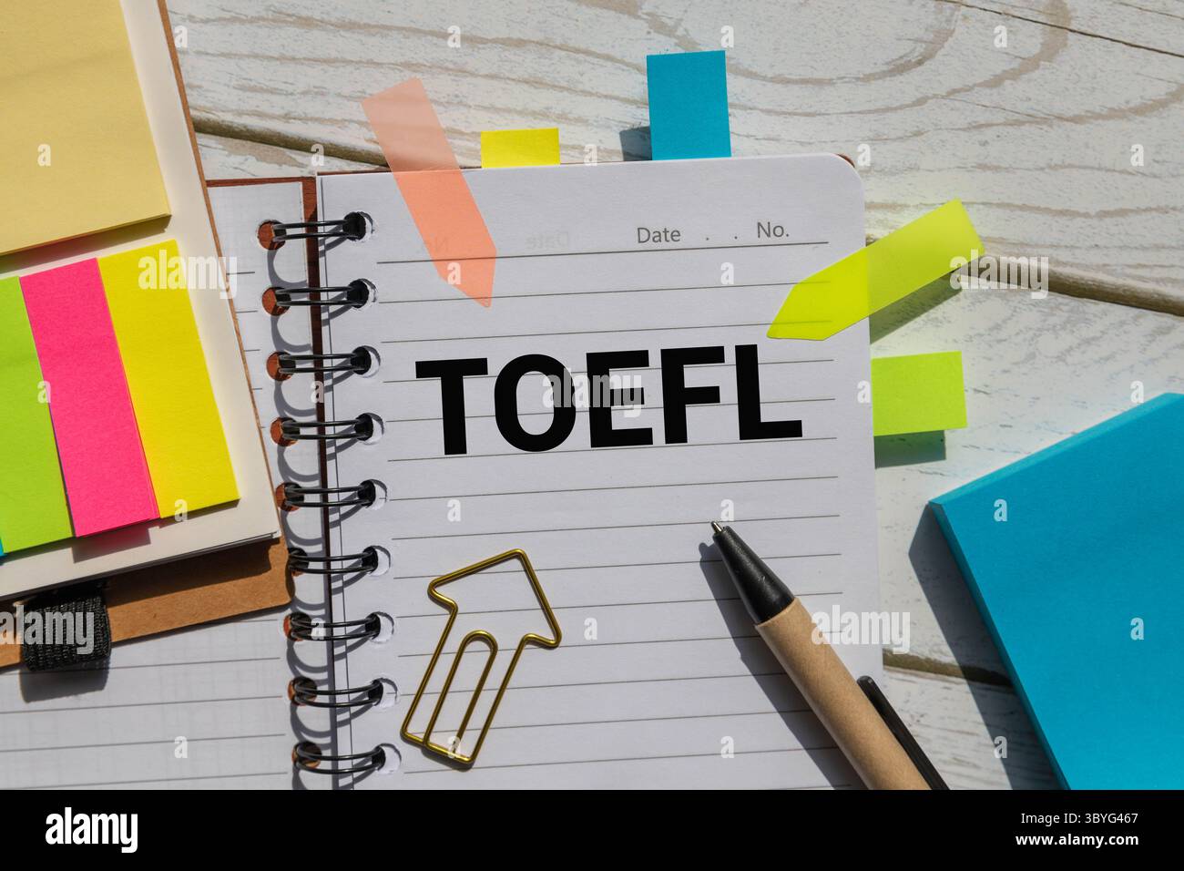 EXAM; Four wooden blocks with EXAM text of concept, a black notebook, a ...