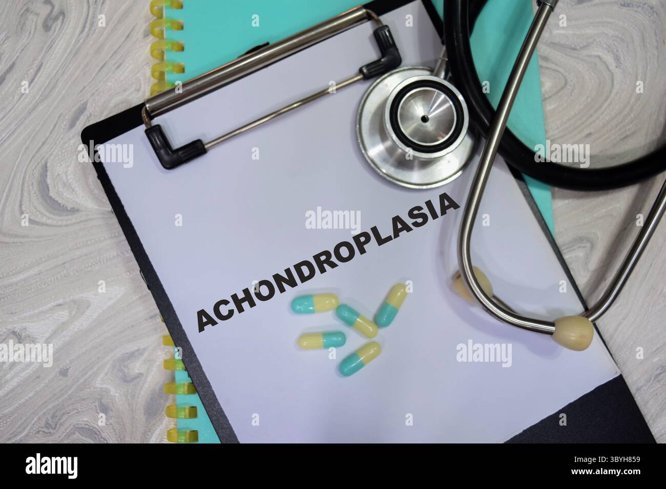 Concept of Achnodroplasia write on clipboard isolated on Wooden Table. healthcare and pharmaceutical concept Stock Photo