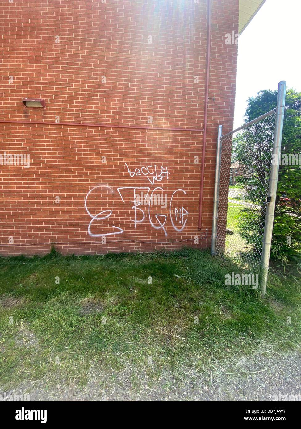 W7M Crips, "BaccWest ETGC" tags seen in Five Points behind an aparment security fence, showing members access - Smartphone Captured Stock Image