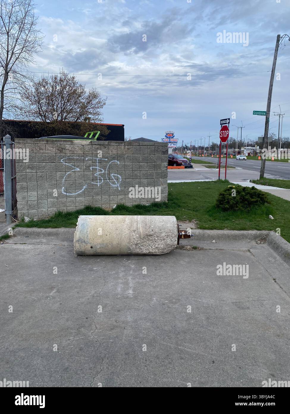 ScoreGang, a Detroit Crips subset, "ETGC" tags seen on dumpster enclosure outside local gas station in Five Points, "3" overlapping "T" - Smartphone Captured Stock Image