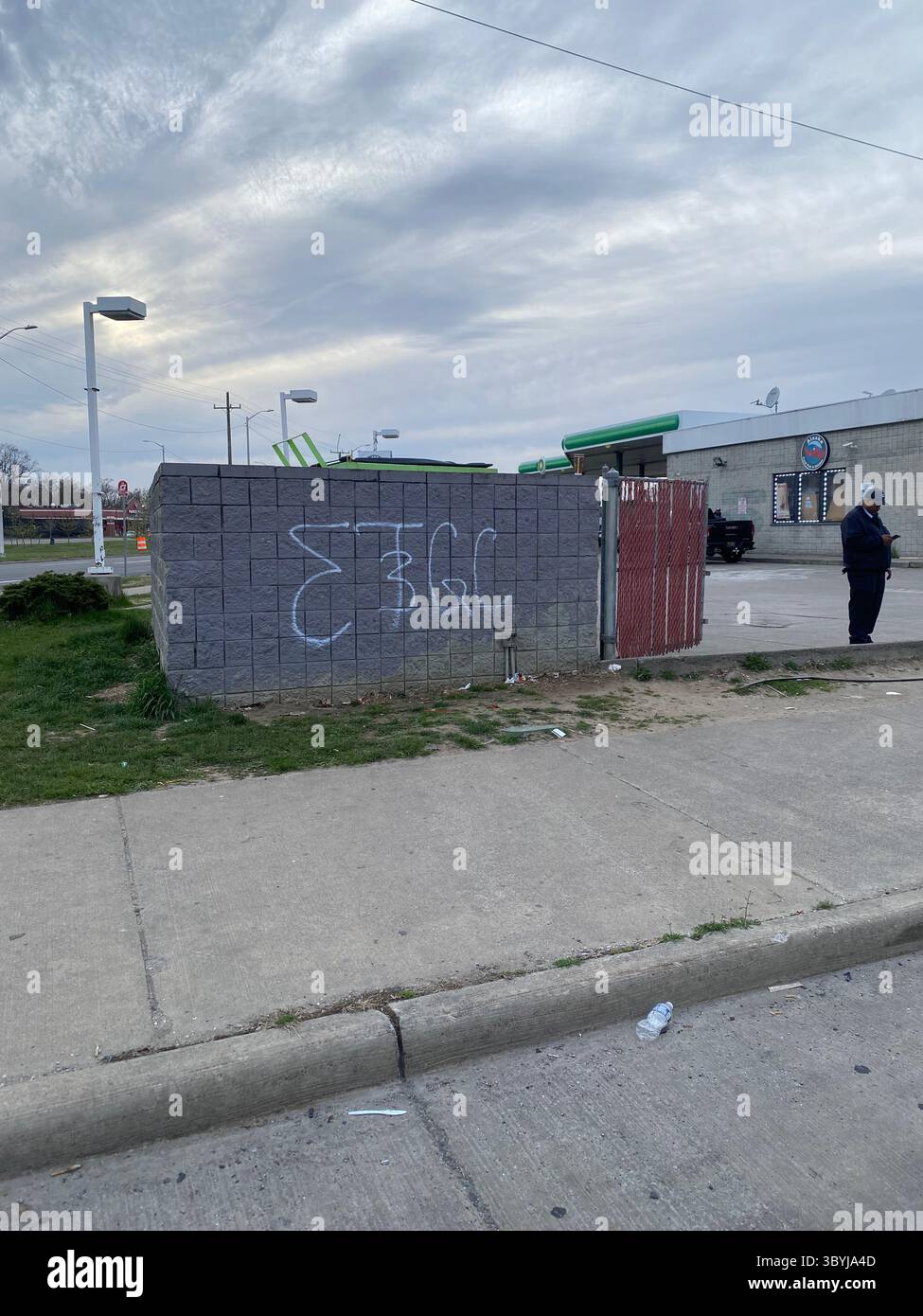 ScoreGang, a Detroit Crips subset, "ETGC" tags seen on dumpster enclosure outside local gas station in Five Points, "3" overlapping "T" - Smartphone Captured Stock Image