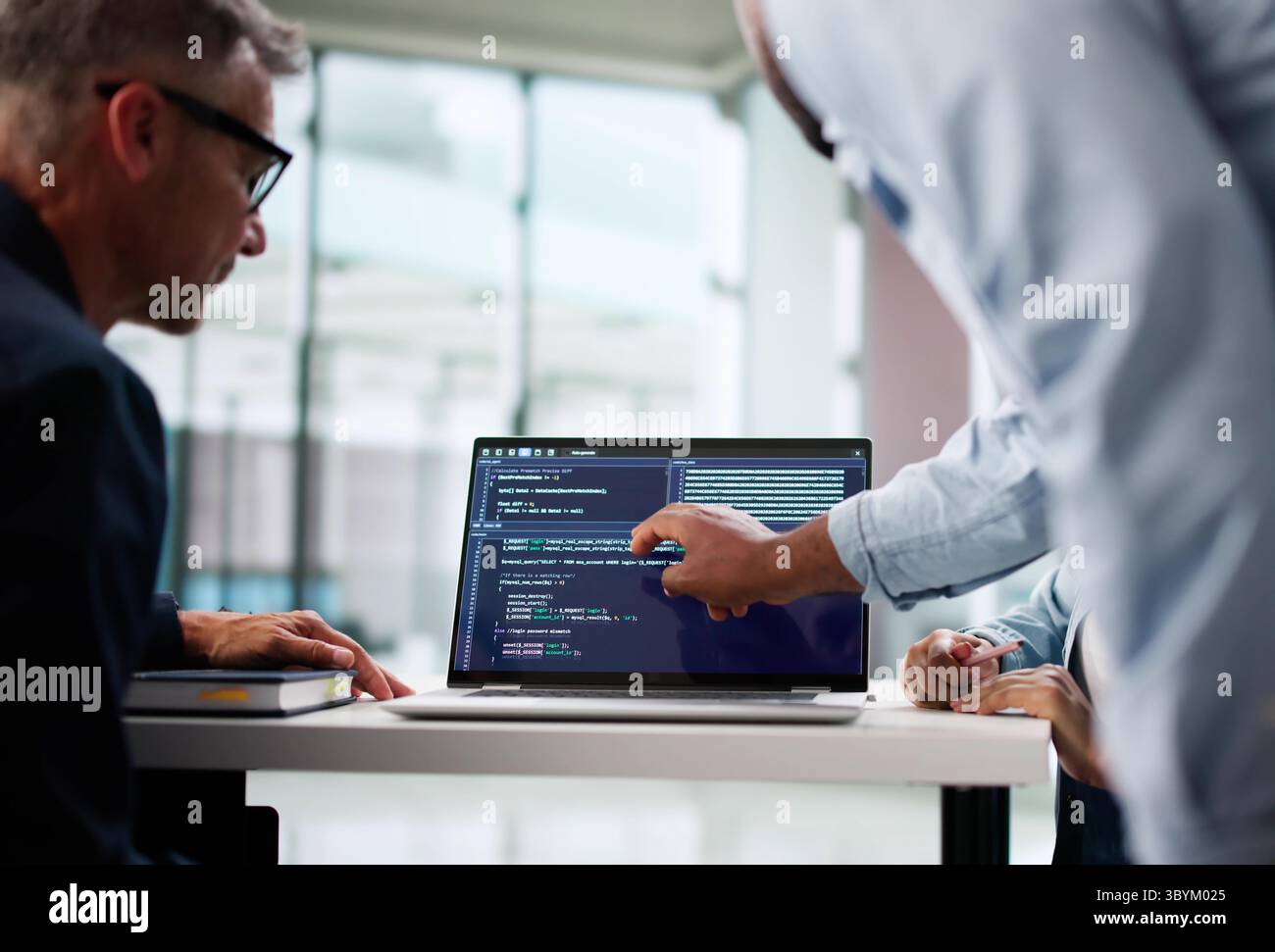 Skilled Programmers Collaborating On Software Development In Modern Office Environment. Stock Photo