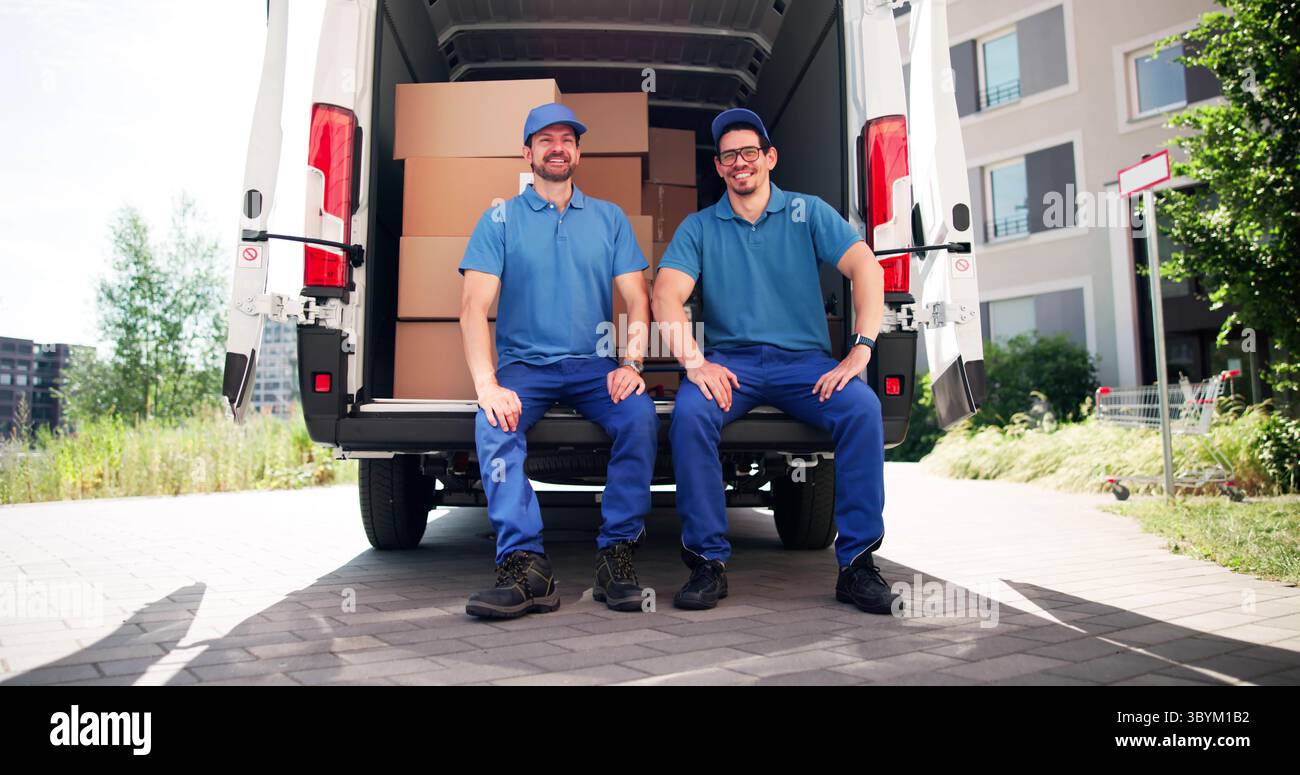 Professional Mover Team Unloading Boxes From Van Into House Stock Photo