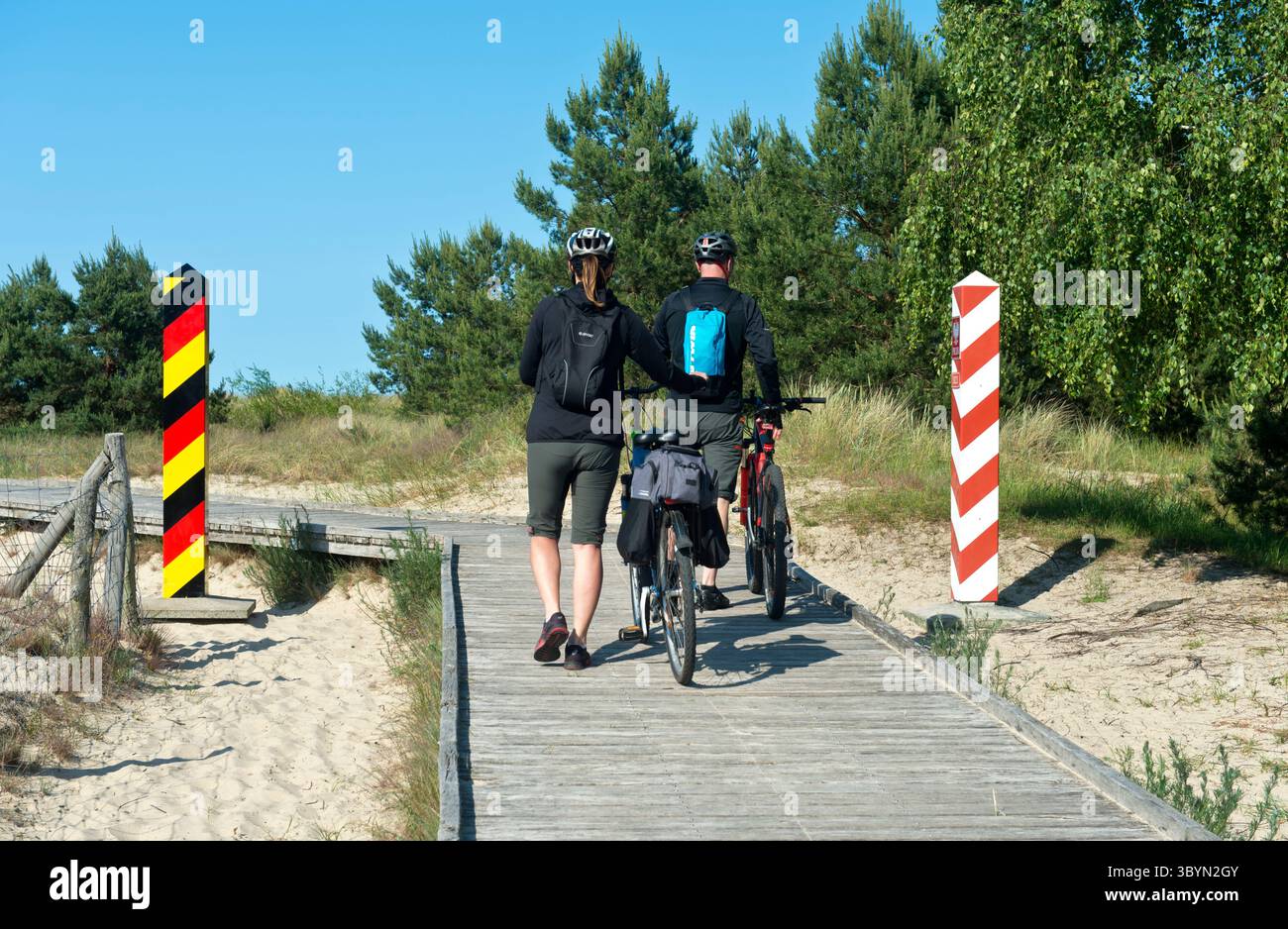 Two bikers on the pedestrian and bicycle path along the German-Polish border near Ahlbeck, Usedom Island, Mecklenburg-Western Pomerania, Germany Stock Photo