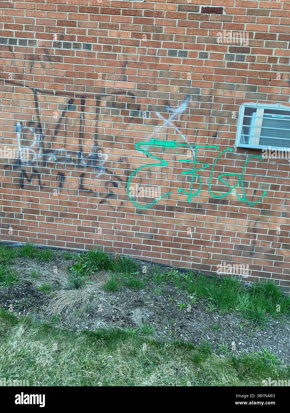 W7M Crips vs RR$C (Rollin’ 60s Crips) tag wars, graffiti cross-outs on Riverview St near West Seven Mile Rd, northwest Detroit (48219) - Smartphone Captured Stock Image