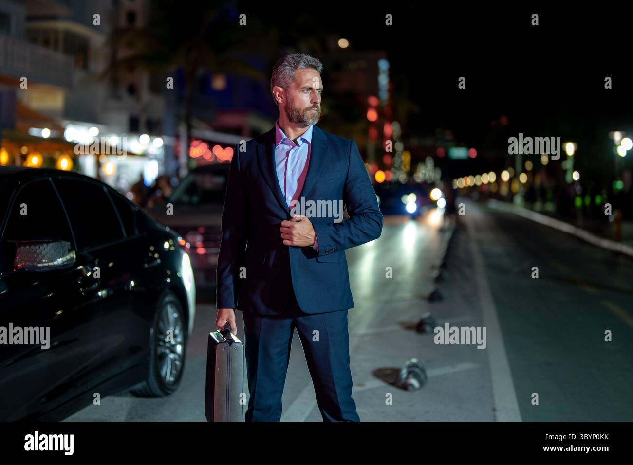 Business man walking at night city. Rich man in a suit walk through ...