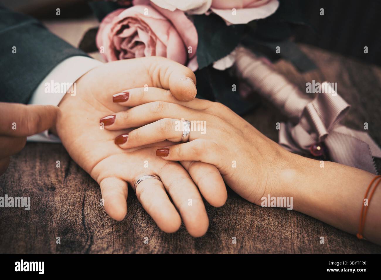 Newly wed couple holding hands Stock Photo