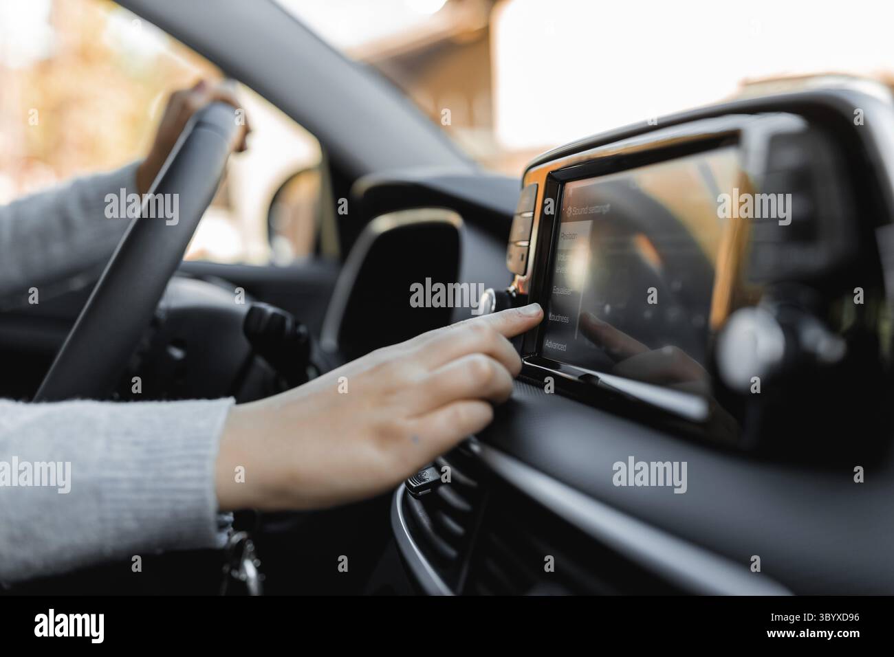 Adjusting Language with touchscreen of a modern car. Driving at a sunny ...