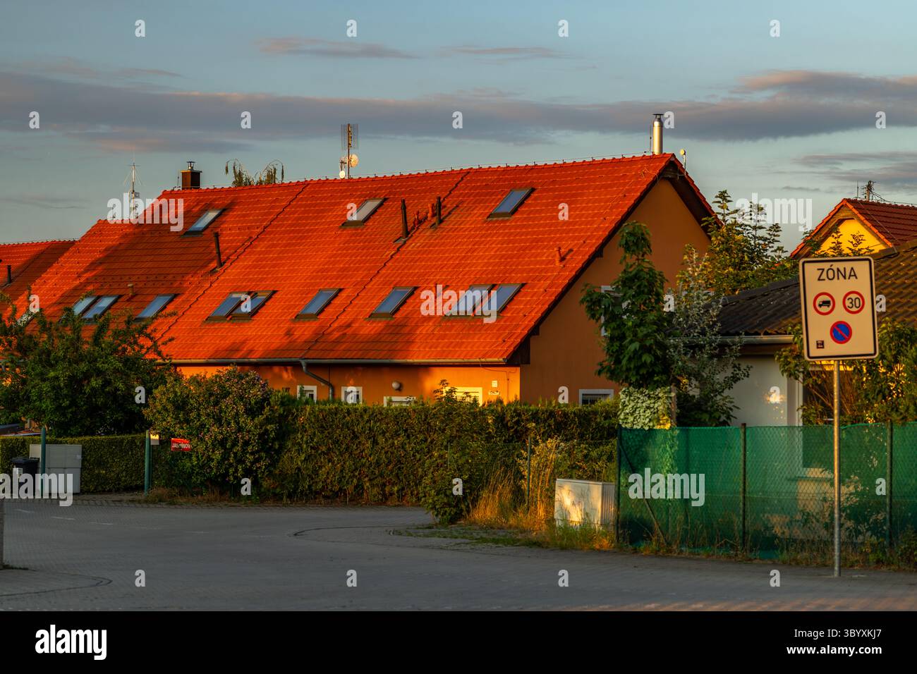 New houses in central Bohemia town with sunset color in Bustehrad town CZ 07 18 2025 Stock Photo