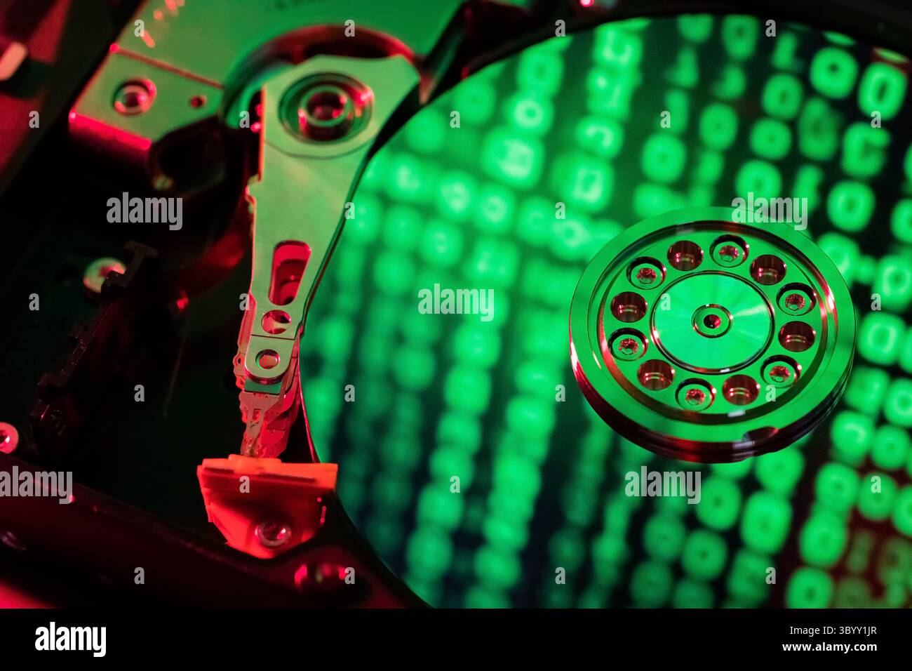 The computer code is displayed in green numbers on the open hard disk Stock Photo