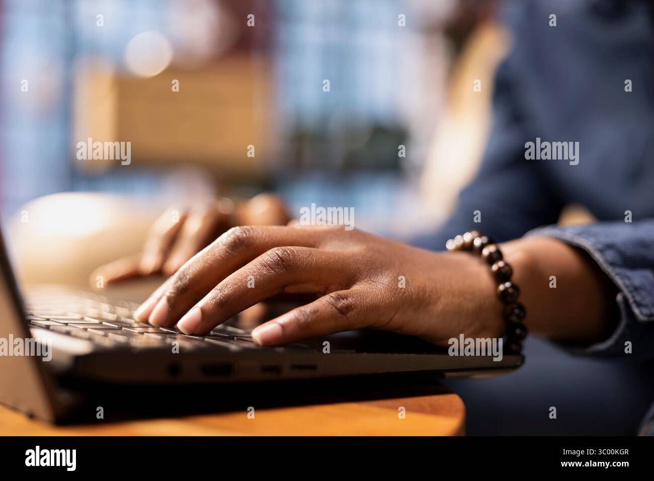 Independent woman using laptop for remote job tasks at home office, doing research and enjoying the benefits of schedule flexibility. Embracing the modern lifestyle of freelance work. Close up. Stock Photo