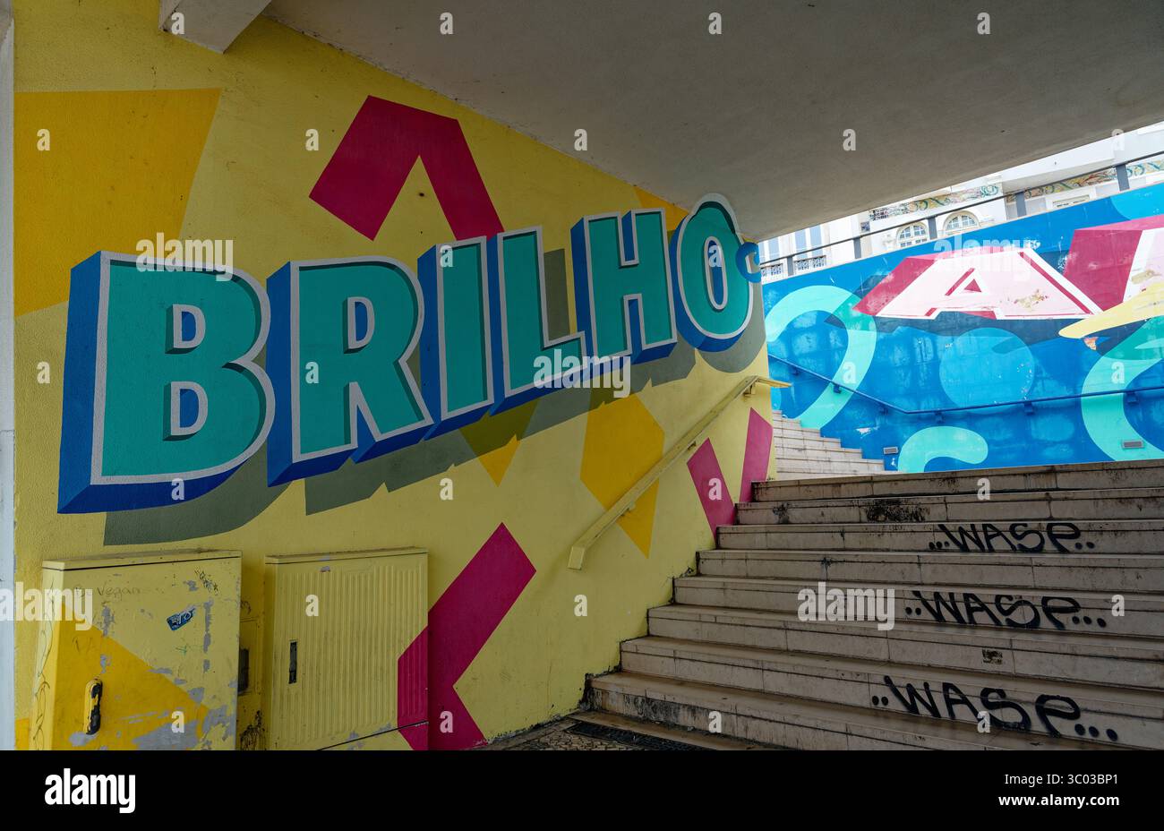 Vibrant urban staircase mural featuring bold 'BRILHO' lettering and playful geometric shapes Stock Photo