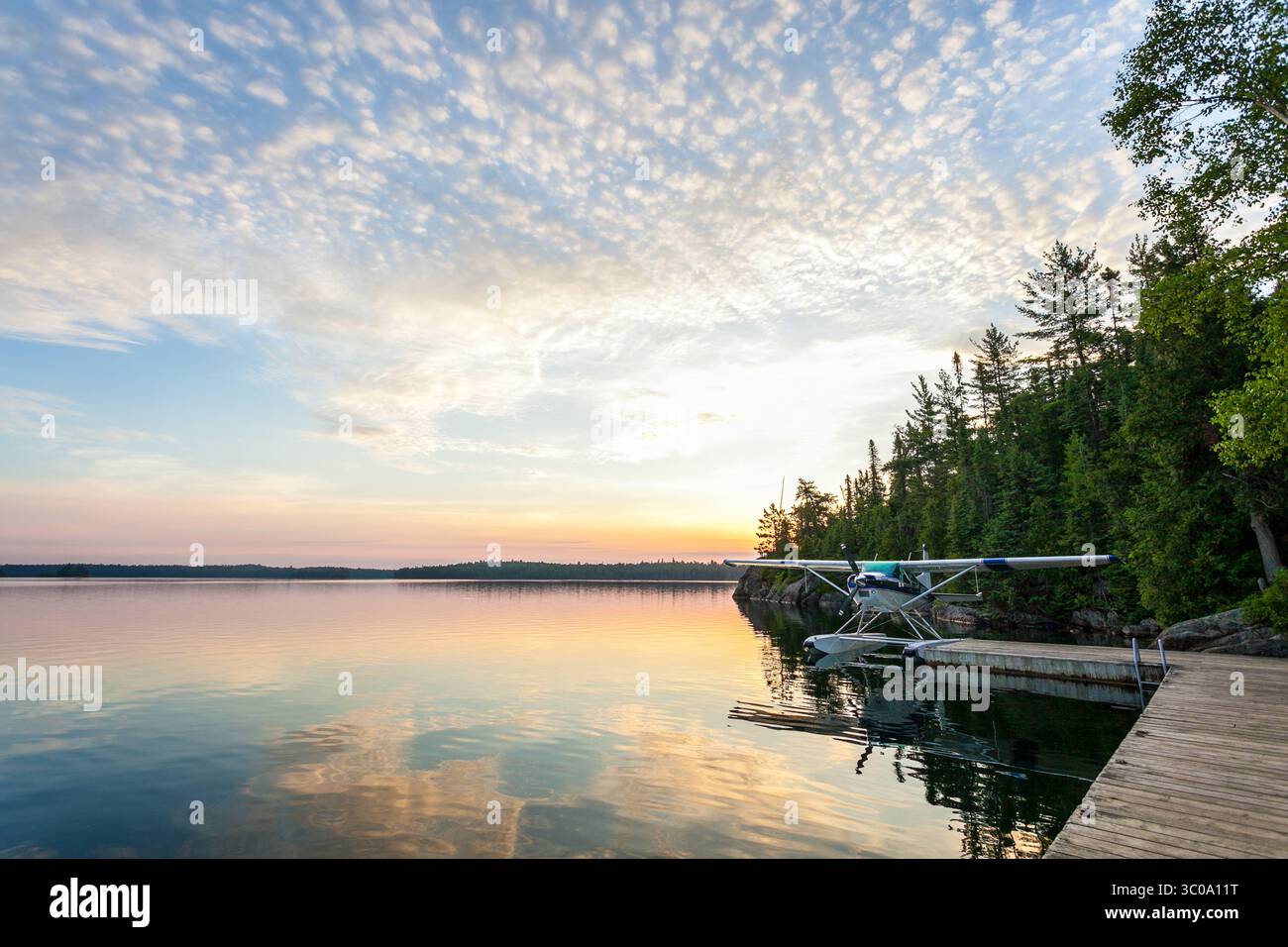 A float plane at sunrise on Lake Temagami in northern Ontario, Canada Stock Photo